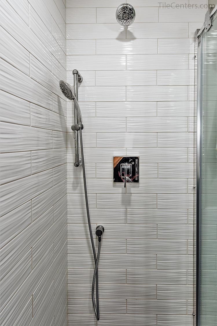White subway tile for shower walls with chrome shower fixtures