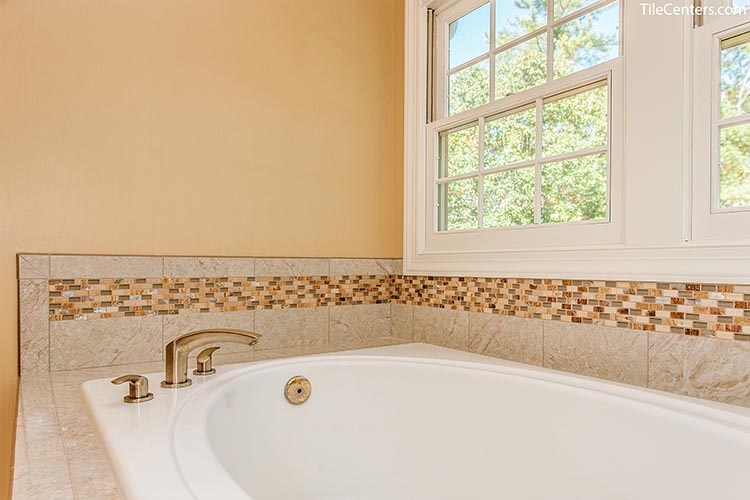 Bathtub with Beige Surround Tile and Brushed Nickel Faucet